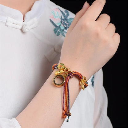 Pulsera Rueda de Oración · Cordón Multicolor