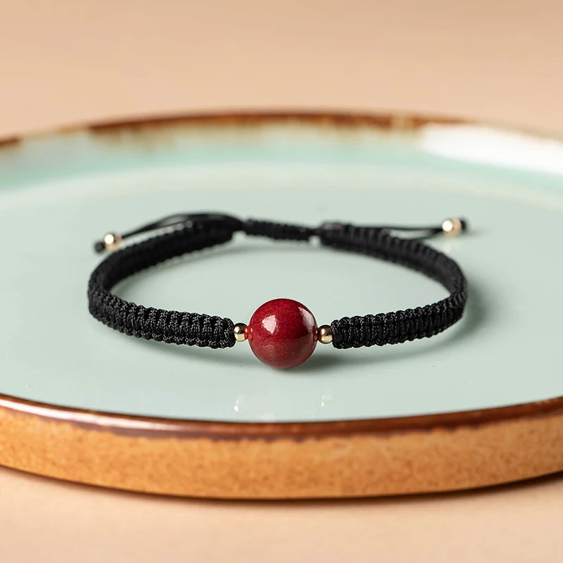 Pulsera roja trenzada con cuenta central